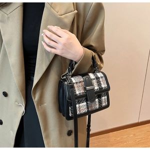 Detail showing tweed texture and metal buckle on women's stylish crossbody square bag