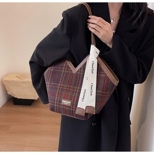 Close-up of vintage plaid tote bag with wool texture and V-shape opening detail