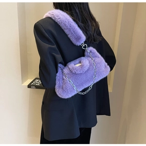 Détail macro du sac en fausse fourrure violette avec fermoir cœur et chaîne argentée