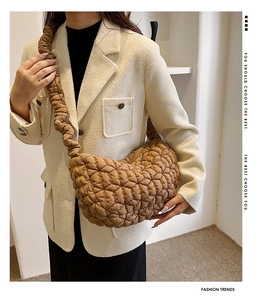 Detail of brown quilted nylon crescent bag with stylish ruched cloud shoulder strap