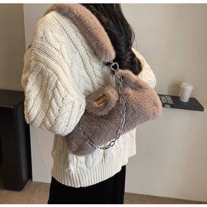 Détail du sac bandoulière en fausse fourrure marron avec chaîne et boucle cœur