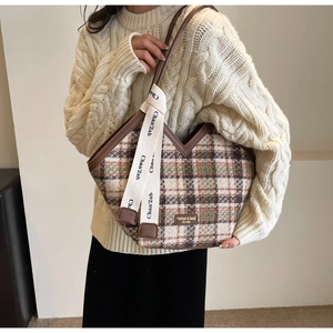 Close-up of retro plaid tote bag with V-shaped opening and decorative ribbon handle