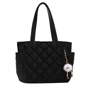 Black quilted nylon tote bag with plush monster charm and large capacity side pockets