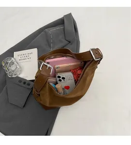 Interior view showing the large capacity of the brown suede bucket bag with daily items