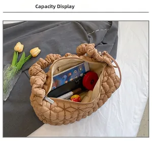 Interior view showing large capacity of the quilted nylon hobo bag with personal items