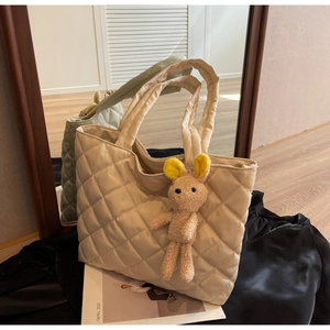 Detailed quilted texture and plush bunny charm on a cream nylon large tote bag