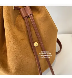 Detail of invisible magnetic buckle on brown suede drawstring backpack for easy closure