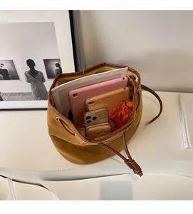Top view of spacious brown suede backpack interior holding tablets and daily items