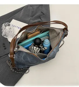Interior view showing the large capacity of the denim shoulder bag with multiple pockets