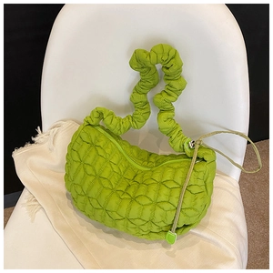 Detailed macro view of apple green quilted nylon fabric and ruched handle texture