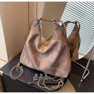 Detail of vintage brown textured backpack with chain strap and large capacity design