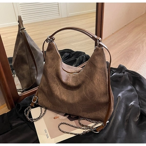 Detailed close-up of large capacity vintage brown crescent shoulder bag with silver chains