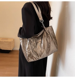 Detail of champagne gold quilted tote bag showing plush texture and metallic finish