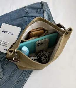 Interior view showing the large capacity and zipper pocket of the khaki canvas bucket bag