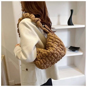 Close-up of brown quilted nylon hobo bag with unique ruched shoulder strap detail