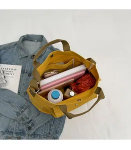 Top view showing spacious interior with pockets of this yellow canvas tote bag