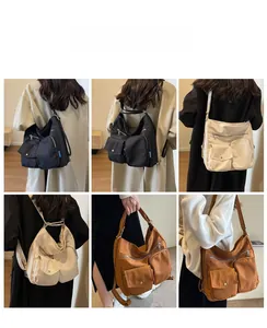 Detail view of multi-pocket nylon crossbody bag in black, off-white, and tan colors