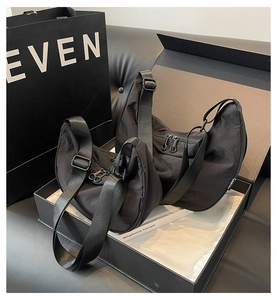 Detail of two black nylon hobo bags in different sizes featuring smooth fabric texture