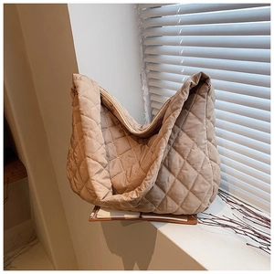 Detail of khaki quilted oxford fabric bucket bag showing soft texture and stitching