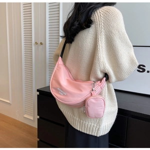 Detail of pink nylon dumpling bag with adjustable strap and mini round coin pouch