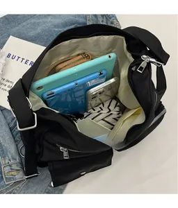 Top view of large nylon crossbody bag interior showing spacious storage for tablet and wallet