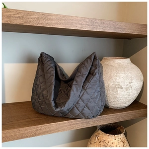 Close-up of charcoal grey quilted hobo bag featuring premium diamond stitching texture