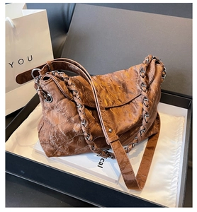 Brown quilted chain bag presented in a premium gift box with elegant packaging