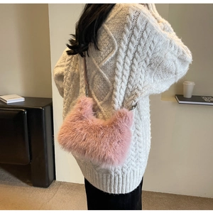 Detail of soft pink faux fur texture and silver metal clasp on crossbody bag