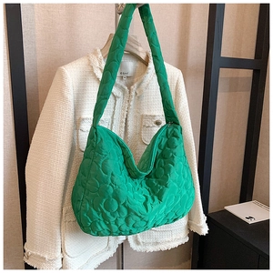 Close-up of green floral quilted nylon hobo bag with wide shoulder strap texture