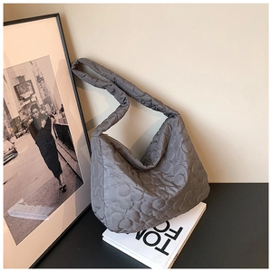 Detailed view of grey quilted oxford fabric shoulder bag with soft cloud texture