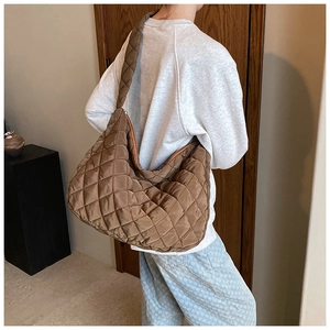 Detail view of brown quilted oxford fabric shoulder bag with padded texture and large capacity