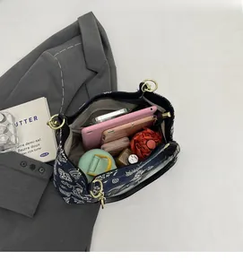 Spacious interior of paisley canvas tote bag holding a tablet, umbrella, and essentials