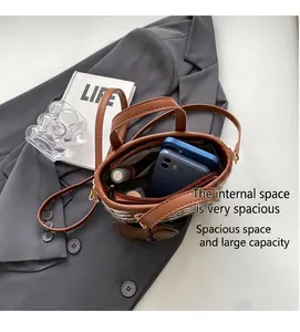 Top view of striped bucket bag interior showing space for two phones and lipstick