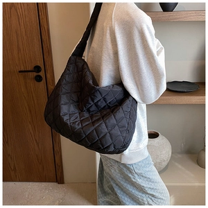 Detailed shot of black quilted oxford cloth shoulder bag with puffy cloud texture