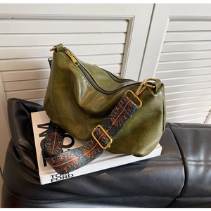 Close-up of vintage dark green hobo bag with ethnic style jacquard wide strap