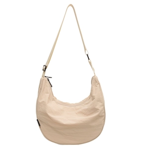 Beige nylon crescent crossbody bag with adjustable strap and textured fabric finish