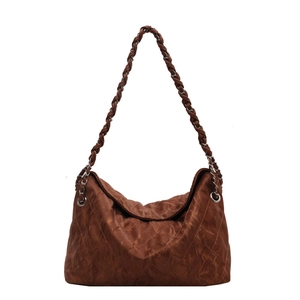 Deep brown quilted large shoulder bag with silver chain strap on a white background