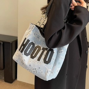 Light blue paisley denim tote bag with chain strap and HOOTO patch for daily street style