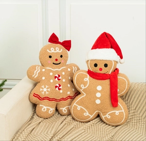 Detailed view of gingerbread plush pillows with intricate embroidery on cozy lamb velvet