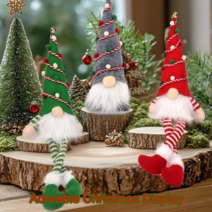 Three glowing Christmas gnomes set with tall hats and striped legs on rustic wooden decor