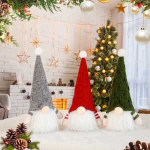Three Christmas gnomes with knitted hats and warm LED lights for holiday home decoration