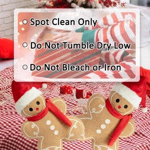 Detail of gingerbread man plush pillows with red scarves on festive checkered background
