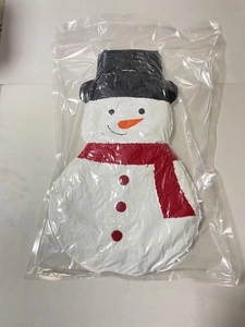 Detail of Christmas snowman towel with red scarf and hat in clear zipper packaging
