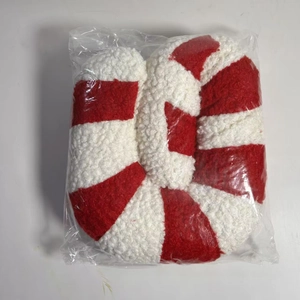 Detail of red and white striped Christmas candy plush pillow in clear packaging