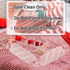 Pink striped candy-shaped plush pillow with cleaning care instructions and holiday decor
