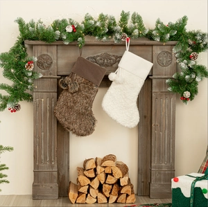 Plush Christmas stockings in brown and white faux fur with pom-poms on a rustic fireplace