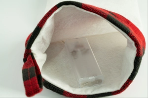 Detail view of the LED battery compartment inside the buffalo plaid Christmas pet stocking