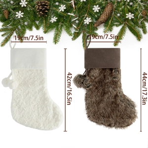 Set of plush Christmas stockings in cream and brown with decorative fur balls and hangers