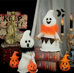Knitted Halloween ghost figurines with feather collars and mini pumpkin candy bag accessories