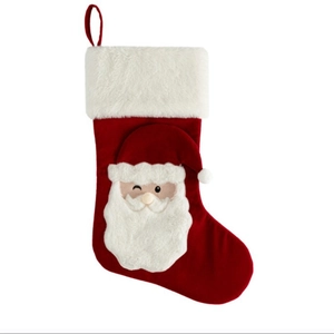 Red Christmas stocking with Santa Claus embroidery and white faux fur trim for decoration